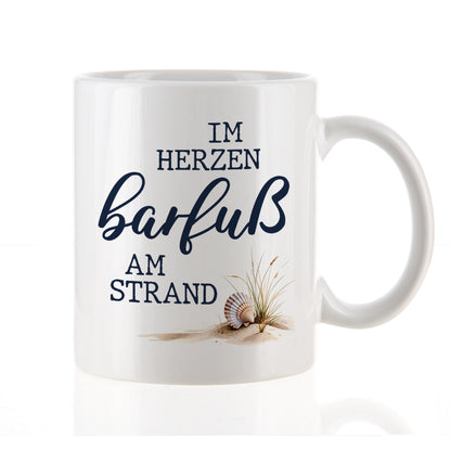 Weiße Tasse mit Spruch „Im Herzen barfuß am Strand“ freigestellt