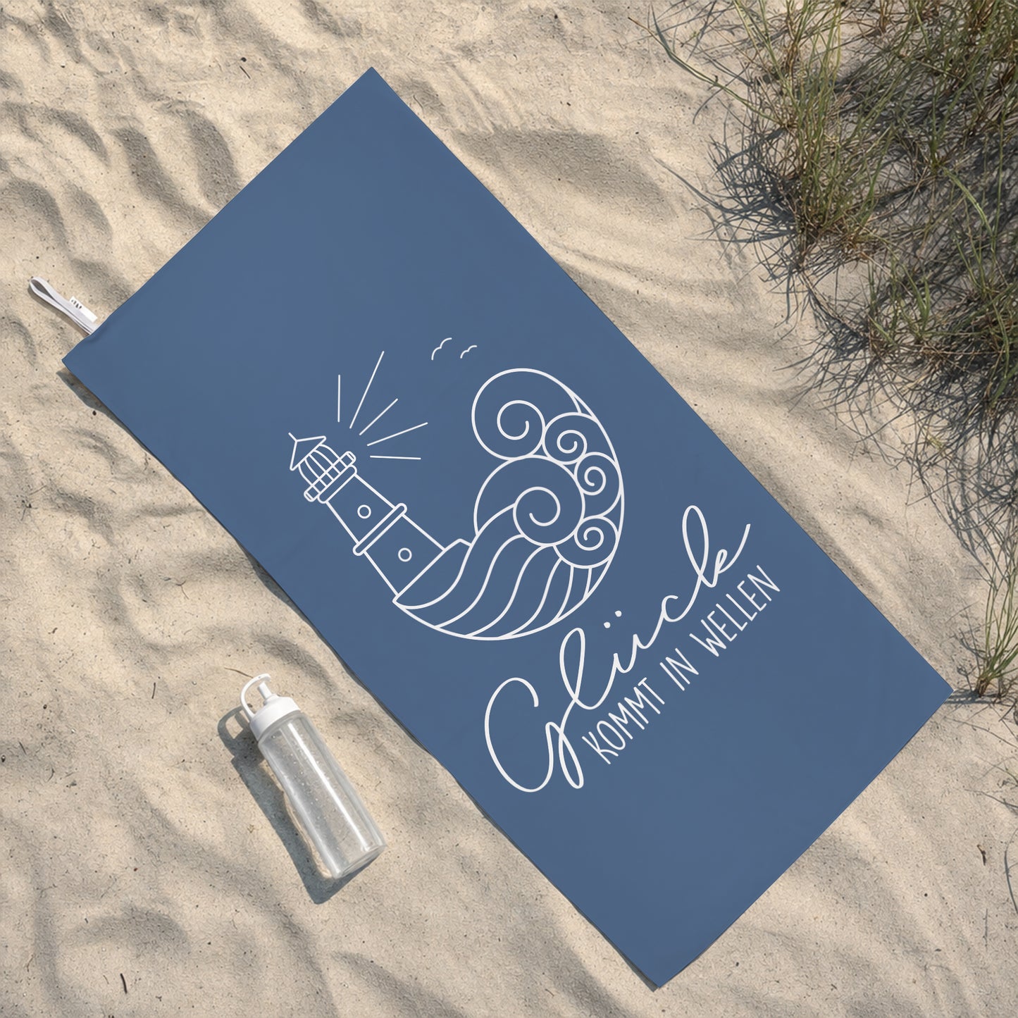 Blaues Sporthandtuch mit Aufdruck Glück kommt in Wellen, Leuchtturm und Wellenmotiv am Strand