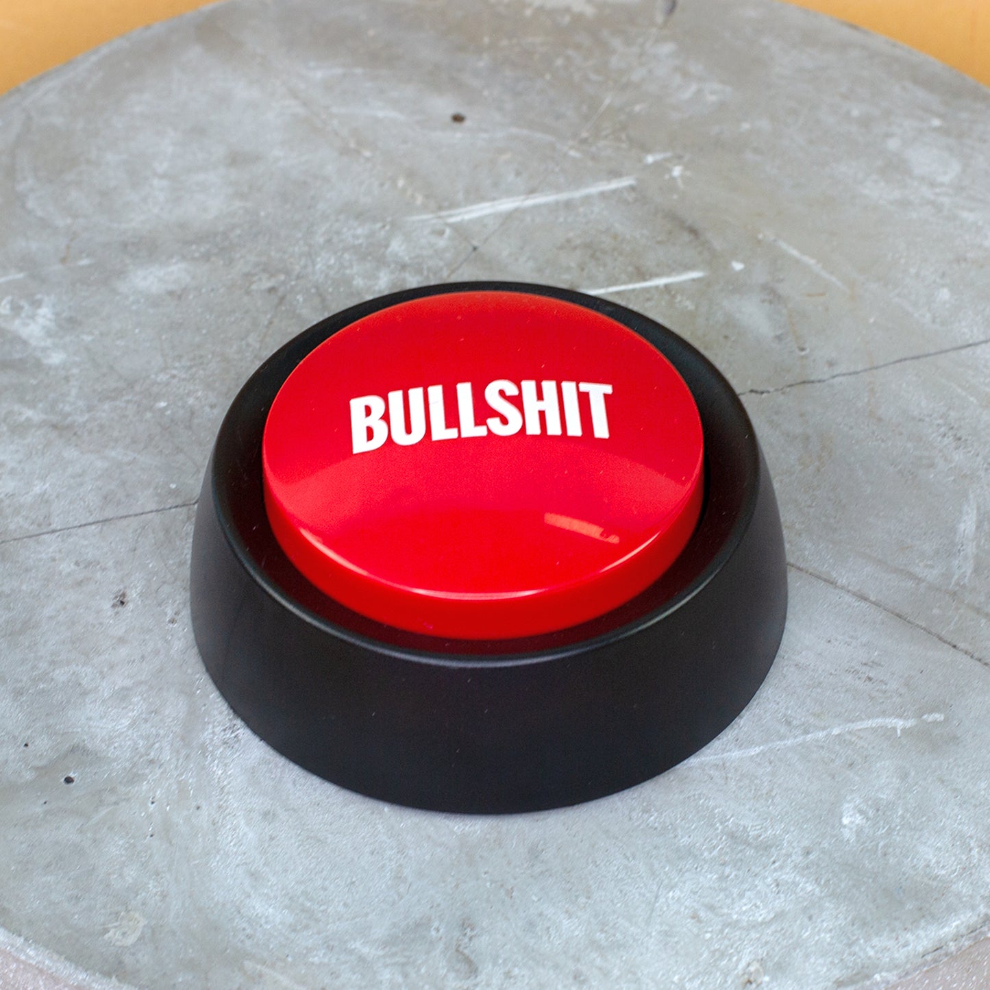 Bullshit Button Sound Button auf einer Betonplatte