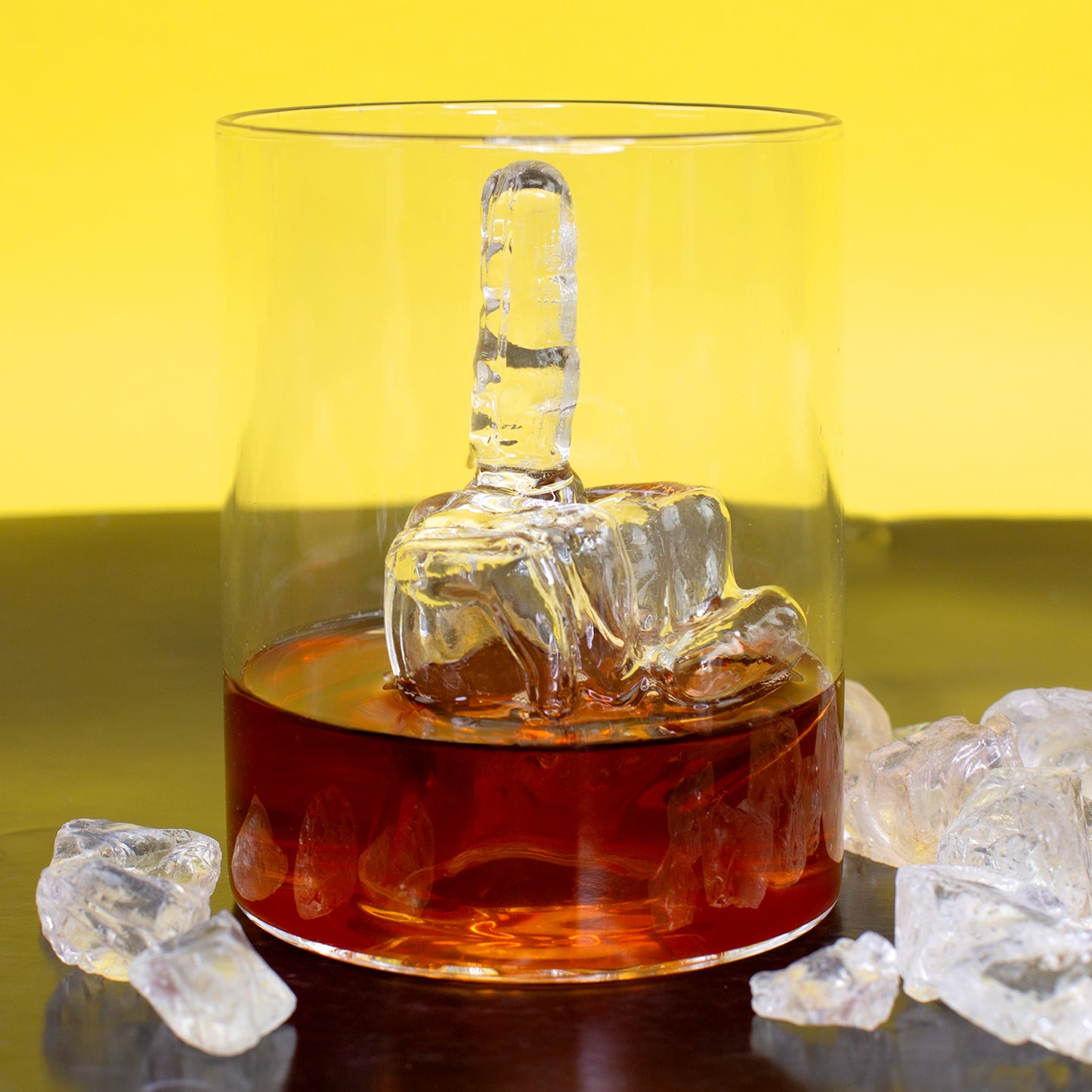 Whiskyglas mit Mittelfinger Figur im Inneren und dunklem Getränk als lustiges Geschenk