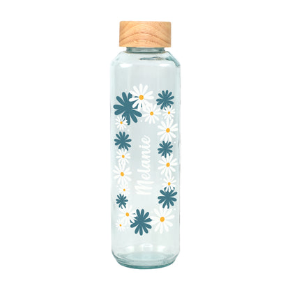 Leere Glasflasche mit Holzdeckel, Blumenmotiv und Name Melanie auf weißem Hintergrund