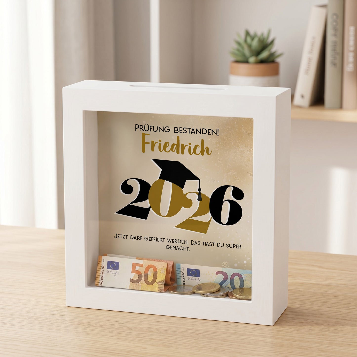 Bilderrahmen Spardose Prüfung bestanden 2026 mit Name Friedrich und Geldgeschenk im weißen Rahmen