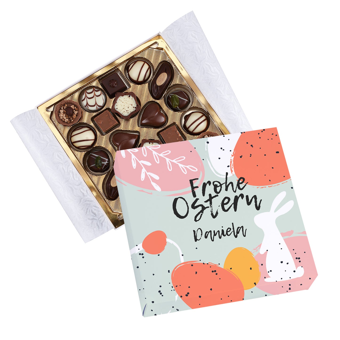 Geöffnete personalisierte Lindt Pralinenbox „Frohe Ostern“ mit Name Daniela und sichtbarem Pralineninhalt