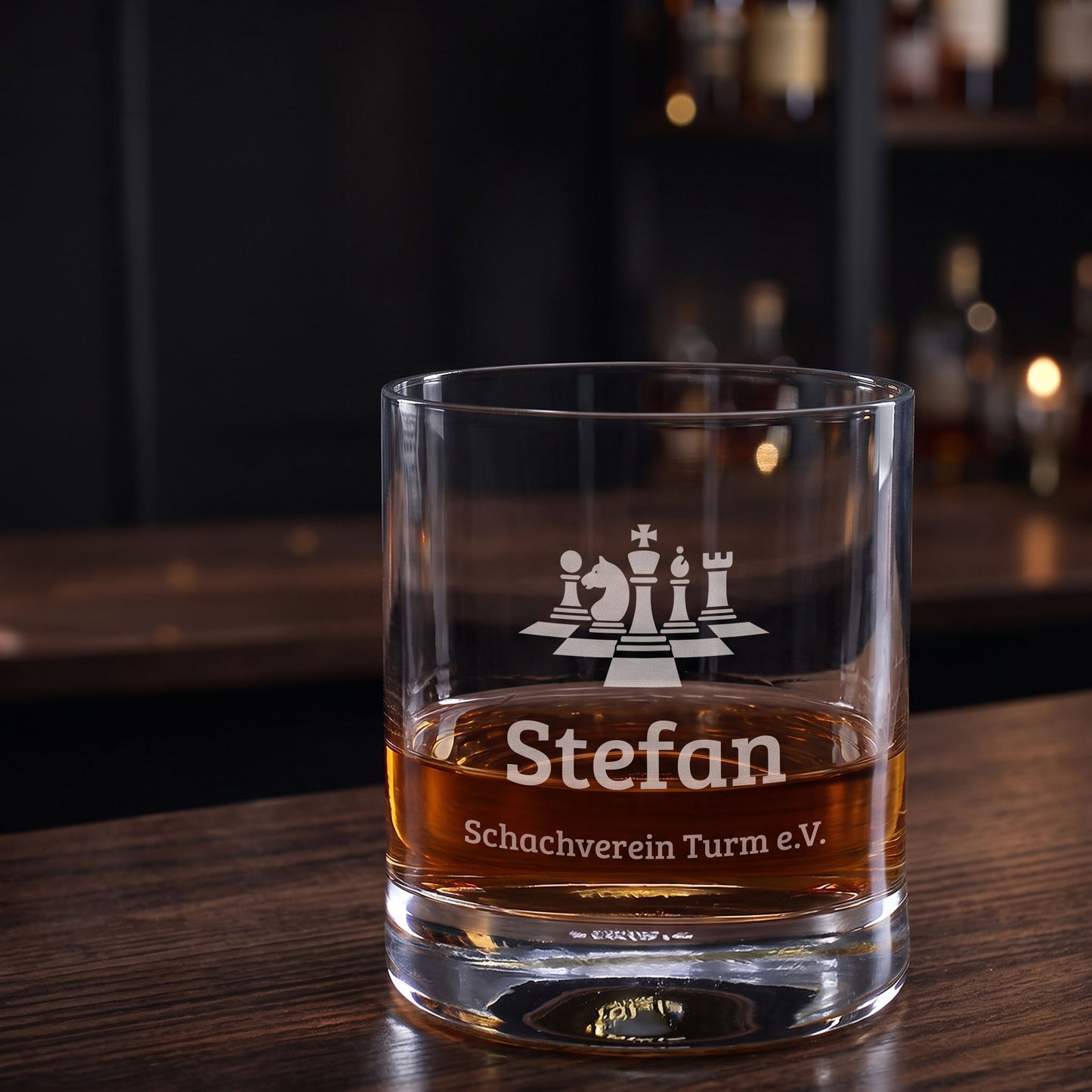 Whiskeyglas mit Schach-Gravur, Name Stefan und Wunschtext Schachverein Turm e.V. auf Holztisch